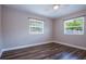 Empty bedroom with hardwood floors, two windows, and freshly painted walls at 770 27Th S Ave, St Petersburg, FL 33705
