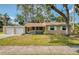 Inviting one-story home featuring a cozy front porch with seating and a lush green lawn at 770 27Th S Ave, St Petersburg, FL 33705