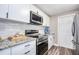Updated kitchen with stainless steel appliances, granite countertops, and modern cabinetry at 770 27Th S Ave, St Petersburg, FL 33705