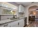 Kitchen with stainless steel dishwasher, white cabinets, and granite countertops at 770 27Th S Ave, St Petersburg, FL 33705