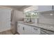 Well-lit kitchen featuring granite countertops, stainless steel appliances, and white cabinets with black hardware at 770 27Th S Ave, St Petersburg, FL 33705