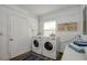 Bright laundry room with modern washer and dryer units, white walls, and decor at 770 27Th S Ave, St Petersburg, FL 33705