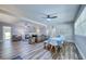 Spacious living room featuring a fireplace, wood floors, ceiling fan, and comfortable seating arrangement at 770 27Th S Ave, St Petersburg, FL 33705