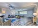 Open-concept living room with abundant natural light, wood floors, ceiling fan, and stylish decor at 770 27Th S Ave, St Petersburg, FL 33705