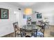 Bright dining space with a glass-top table, view to living area, and adjacent built-in shelving at 7801 11Th N St # 104, St Petersburg, FL 33702