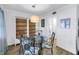 Cozy dining area with a glass table, unique chairs, and adjacent built-in shelving at 7801 11Th N St # 104, St Petersburg, FL 33702
