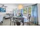Comfortable dining area with glass table, stylish chairs, and view to living area at 7801 11Th N St # 104, St Petersburg, FL 33702