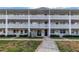 A three story condo exterior with concrete block facade and gated entry at 7801 11Th N St # 104, St Petersburg, FL 33702