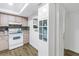 Kitchen with white cabinets, wood accents, tile backsplash, and modern appliances at 7801 11Th N St # 104, St Petersburg, FL 33702