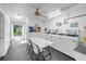 Clean laundry room with multiple washers and dryers, table, chairs, and ceiling fan at 7801 11Th N St # 104, St Petersburg, FL 33702