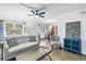 Bright living room featuring a comfortable sofa, stylish decor, and ample natural light at 7801 11Th N St # 104, St Petersburg, FL 33702