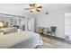 Bright primary bedroom with mirrored closet doors and ceiling fan at 7801 11Th N St # 104, St Petersburg, FL 33702