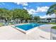 Sparkling community pool with sun loungers, set in lush green surroundings with clear blue skies at 7801 11Th N St # 104, St Petersburg, FL 33702