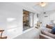 Bright sunroom features tile flooring, sliding glass doors, and comfortable seating area for relaxation at 7801 11Th N St # 104, St Petersburg, FL 33702