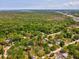 Aerial view of treed lot in a neighborhood with established homes and a green landscape at 7813 Cadillac Ave, Hudson, FL 34667