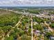 An aerial view of a treed lot close to the highway, stores and town at 7813 Cadillac Ave, Hudson, FL 34667