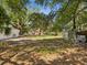 Expansive backyard with mature trees, providing ample shade and a sense of privacy at 7813 Cadillac Ave, Hudson, FL 34667