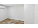 Bright bedroom featuring wood-look floors, white walls, and a modern wall-mounted AC unit at 7813 Cadillac Ave, Hudson, FL 34667