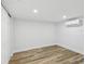Bright bedroom with a closet, white walls, an AC unit, and wood-look flooring at 7813 Cadillac Ave, Hudson, FL 34667