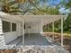 Covered carport attached to a well-maintained home, offering convenient parking and protection at 7813 Cadillac Ave, Hudson, FL 34667