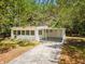 Charming single-story home with a covered parking area and a well-maintained concrete driveway at 7813 Cadillac Ave, Hudson, FL 34667