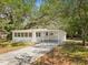 Charming single-story home featuring a convenient carport and freshly painted exterior at 7813 Cadillac Ave, Hudson, FL 34667