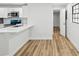 Bright kitchen features stainless steel appliances, white cabinetry, and wood-look flooring at 7813 Cadillac Ave, Hudson, FL 34667