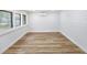 Well-lit room features vinyl flooring, air conditioning, and windows at 7813 Cadillac Ave, Hudson, FL 34667