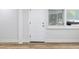 Interior shot featuring a vinyl floor, new baseboards, a new door and a window at 7813 Cadillac Ave, Hudson, FL 34667