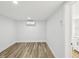 Clean, minimalist room with vinyl flooring, air conditioning, and access to additional spaces at 7813 Cadillac Ave, Hudson, FL 34667