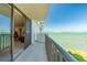 Balcony view featuring ocean and city in the distance with outdoor access from the unit at 80 Rogers St # 6D, Clearwater, FL 33756