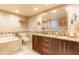 Modern bathroom features double sinks, a soaking tub, and a toilet at 80 Rogers St # 6D, Clearwater, FL 33756
