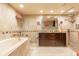 Bathroom featuring double sinks, a soaking tub, and a walk-in shower at 80 Rogers St # 6D, Clearwater, FL 33756