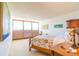 Cozy bedroom featuring a floral bedspread, large windows, and natural light at 80 Rogers St # 6D, Clearwater, FL 33756