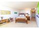 Bright bedroom with a wooden bed frame, shelving, and art at 80 Rogers St # 6D, Clearwater, FL 33756
