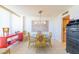 Bright dining room featuring a glass table, chairs and a modern lighting fixture at 80 Rogers St # 6D, Clearwater, FL 33756