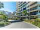 A circular driveway leading to the building's entrance with lush landscaping and a covered area at 80 Rogers St # 6D, Clearwater, FL 33756