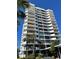Stunning high-rise condo building with private balconies and lush palm trees under a bright blue sky at 80 Rogers St # 6D, Clearwater, FL 33756