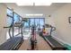 Well-equipped fitness center with treadmills and elliptical machines offering stunning views of the outside at 80 Rogers St # 6D, Clearwater, FL 33756
