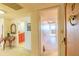 Hallway with tile flooring, a table, and a decorative mirror leads to the front door at 80 Rogers St # 6D, Clearwater, FL 33756
