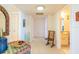 Bright hallway with tile floors leads to a bathroom, closet, and front door at 80 Rogers St # 6D, Clearwater, FL 33756
