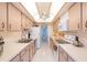 Well-lit galley kitchen with ample cabinet space and modern appliances at 80 Rogers St # 6D, Clearwater, FL 33756