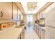 Galley kitchen with classic cabinets and appliances, ample countertop space at 80 Rogers St # 6D, Clearwater, FL 33756