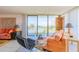 Inviting living room with water views, contemporary furniture, and bright natural light at 80 Rogers St # 6D, Clearwater, FL 33756