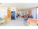 Spacious living area with contemporary decor, tile flooring, and an adjacent kitchen at 80 Rogers St # 6D, Clearwater, FL 33756