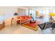 Spacious living room features a colorful sofa, glass table, and large windows at 80 Rogers St # 6D, Clearwater, FL 33756