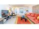 Cozy living room features vibrant decor, modern furniture, and a TV entertainment center at 80 Rogers St # 6D, Clearwater, FL 33756