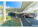 Covered parking area showcasing assigned parking spaces and lush greenery, ensuring convenience and shade at 80 Rogers St # 6D, Clearwater, FL 33756