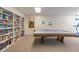 Recreation room featuring a pool table, bookshelves, artwork, and a treadmill for leisure and fitness at 80 Rogers St # 6D, Clearwater, FL 33756