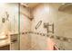 Glass shower with stone flooring, shower head, and grab bar at 80 Rogers St # 6D, Clearwater, FL 33756